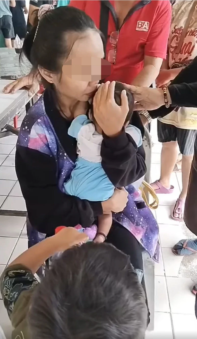 Woman holds her 6-month-old baby