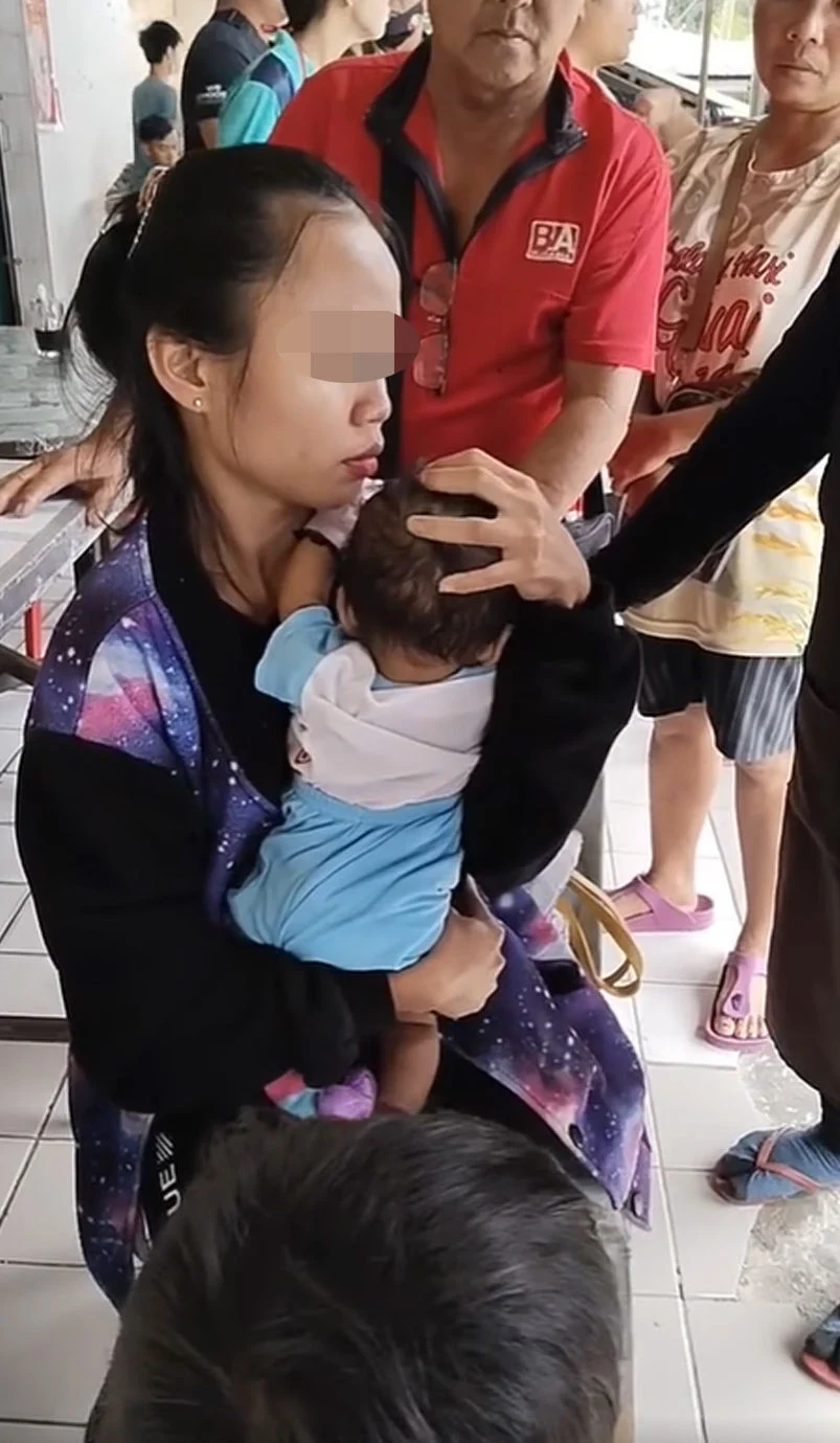 Woman holds her 6-month-old baby
