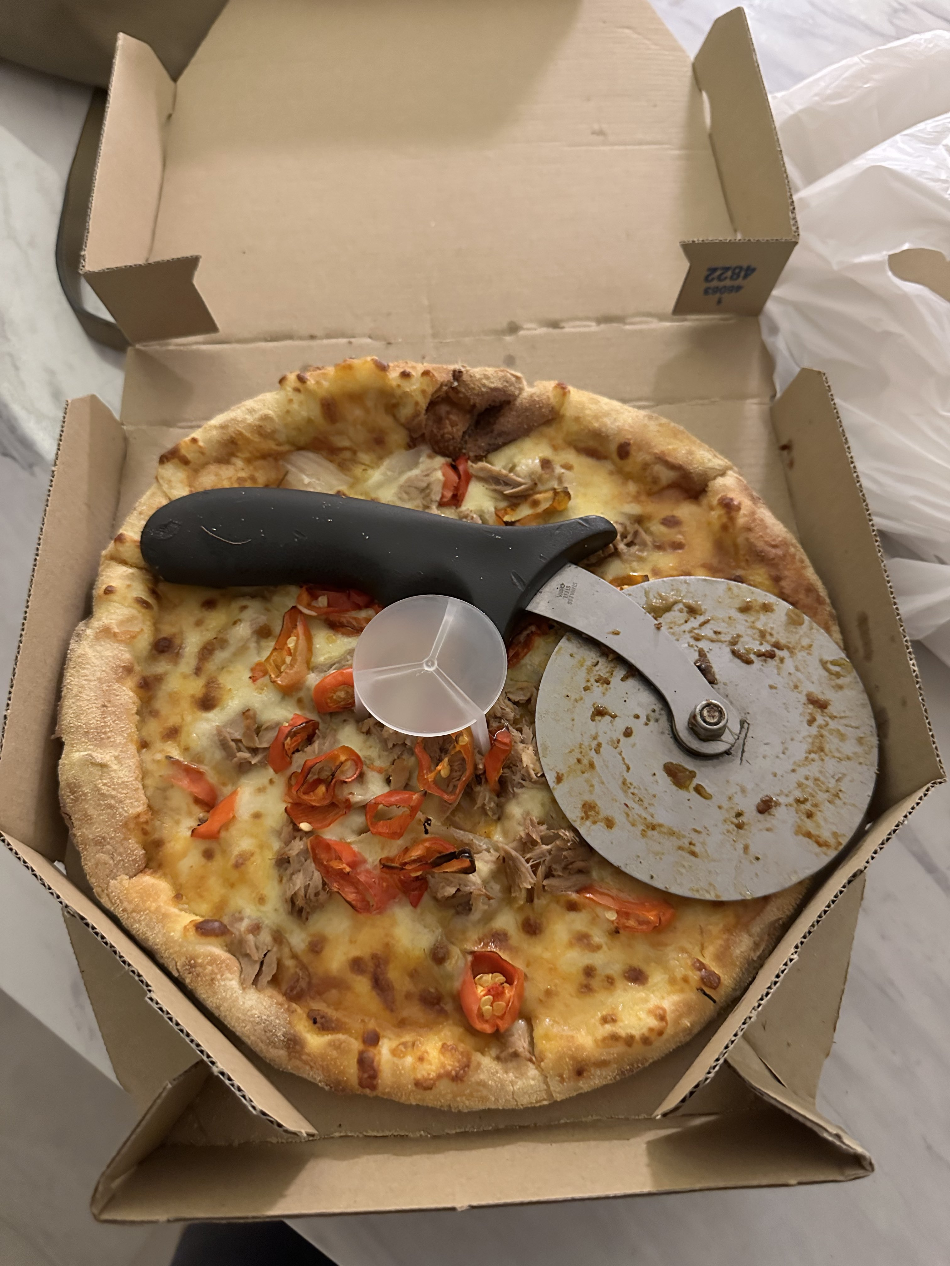 Pizza cutter inside pizza box