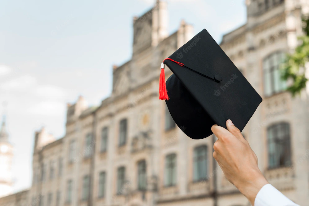 Hand holding a mortarboard