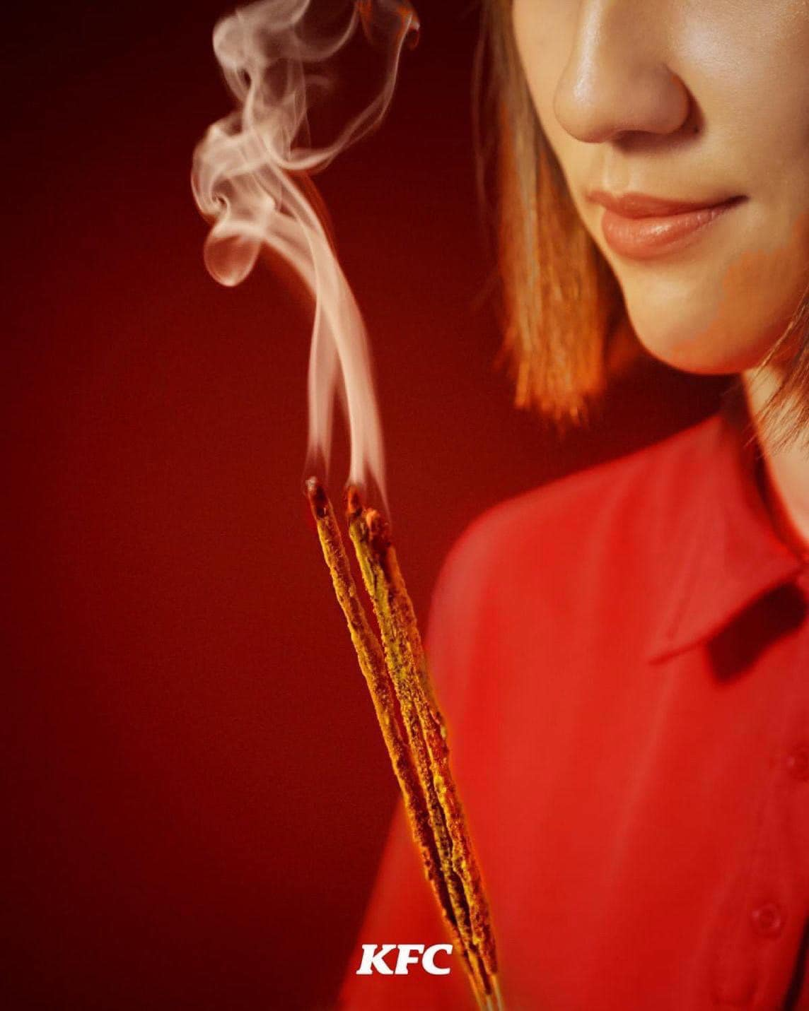 Woman holding fried chicken incense sticks