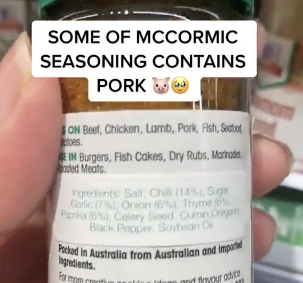 Woman holding a bottle of McCormick Cajun Seasoning