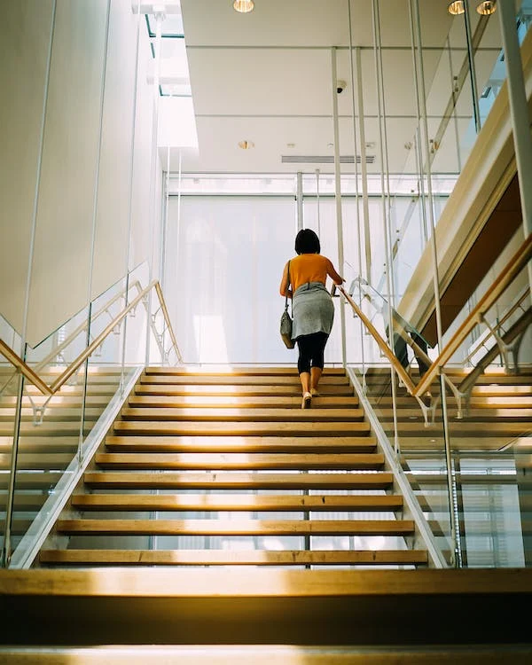 Woman walking up a flight of stairs