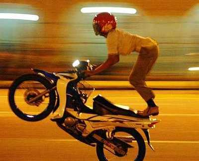 Mat rempit doing a stunt on his motorbike