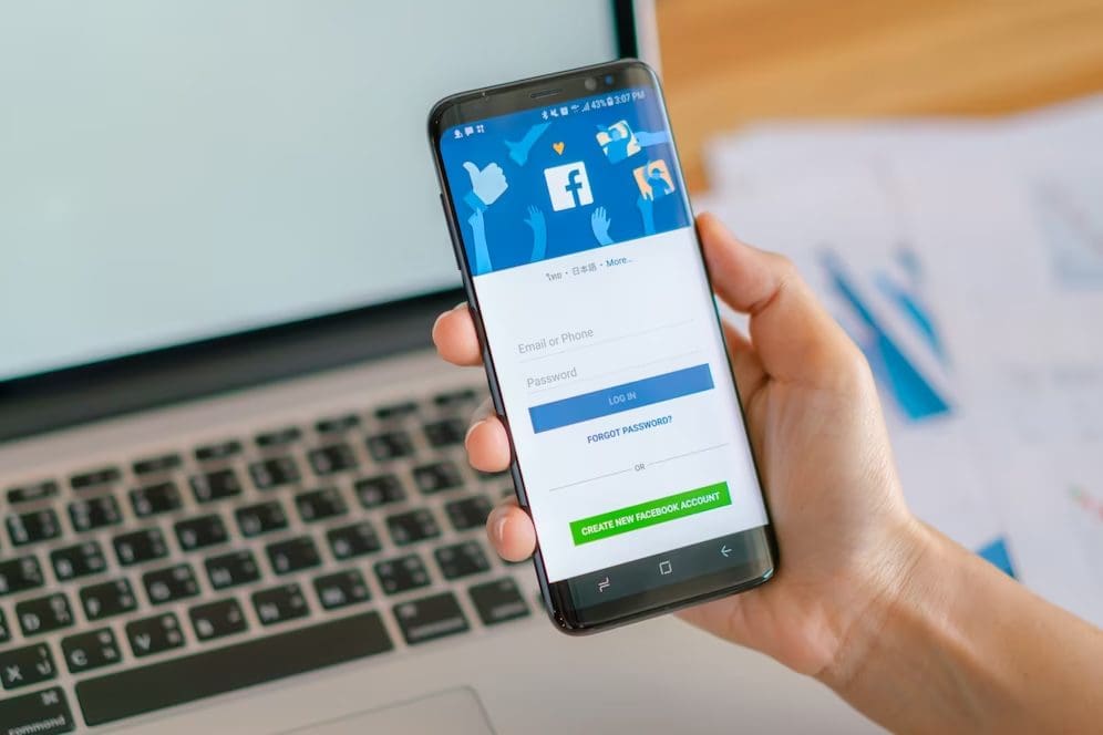 Man using Facebook on his handphone