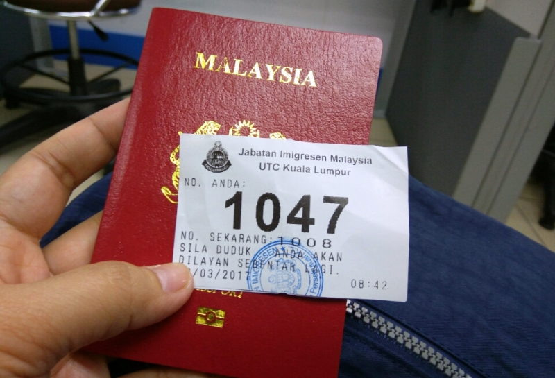 Malaysian passport with queue number
