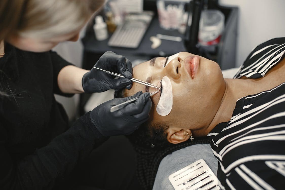 Woman having eyelash extensions
