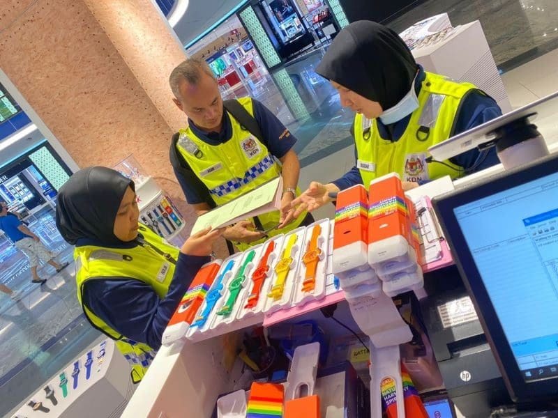 Officers from Ministry of Home Affairs raiding a Swatch outlet