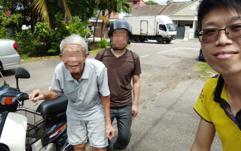 Msian uncle along with the motorcycle that he donated to a student