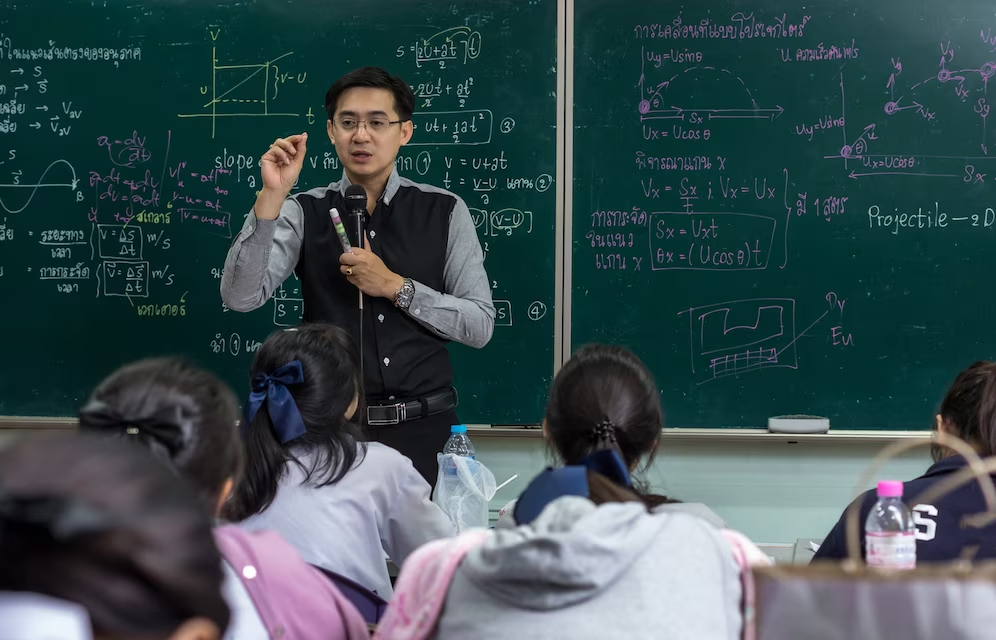 A male asian teacher in a class room