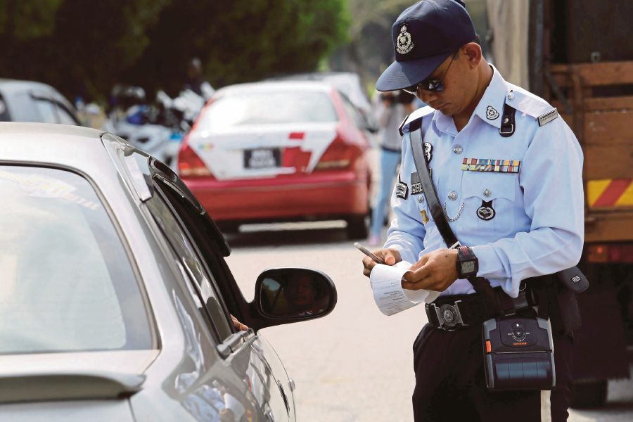 Malaysian traffic police giving a summon