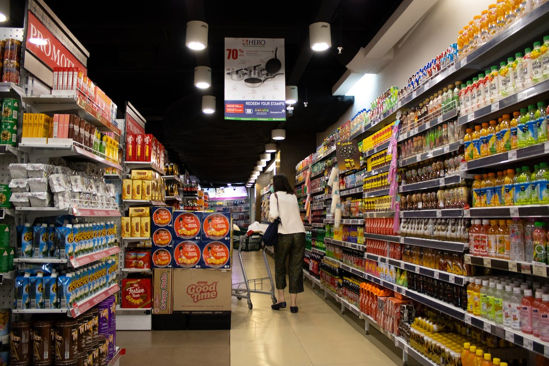 Woman with a trolley at a supermarket