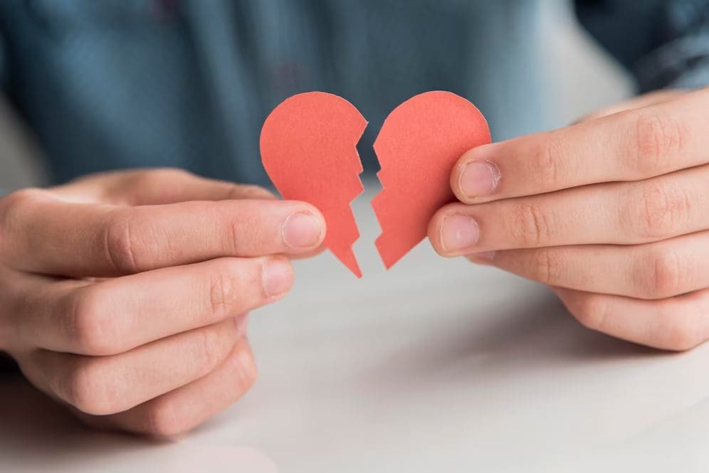 Man holding a broken heart