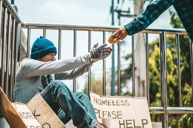 Man helping a beggar