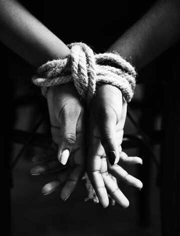 Woman's hands tied up with a rope