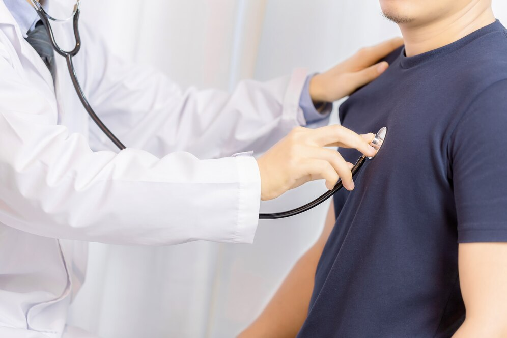 Doctor examining a male patient