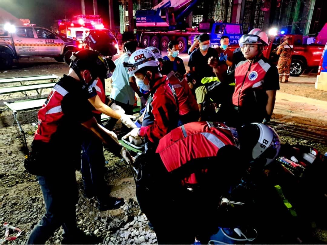Rescuers helping victims after building collapses in Penang