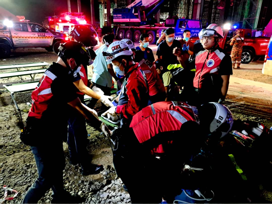 Rescuers helping victims after building collapses in penang