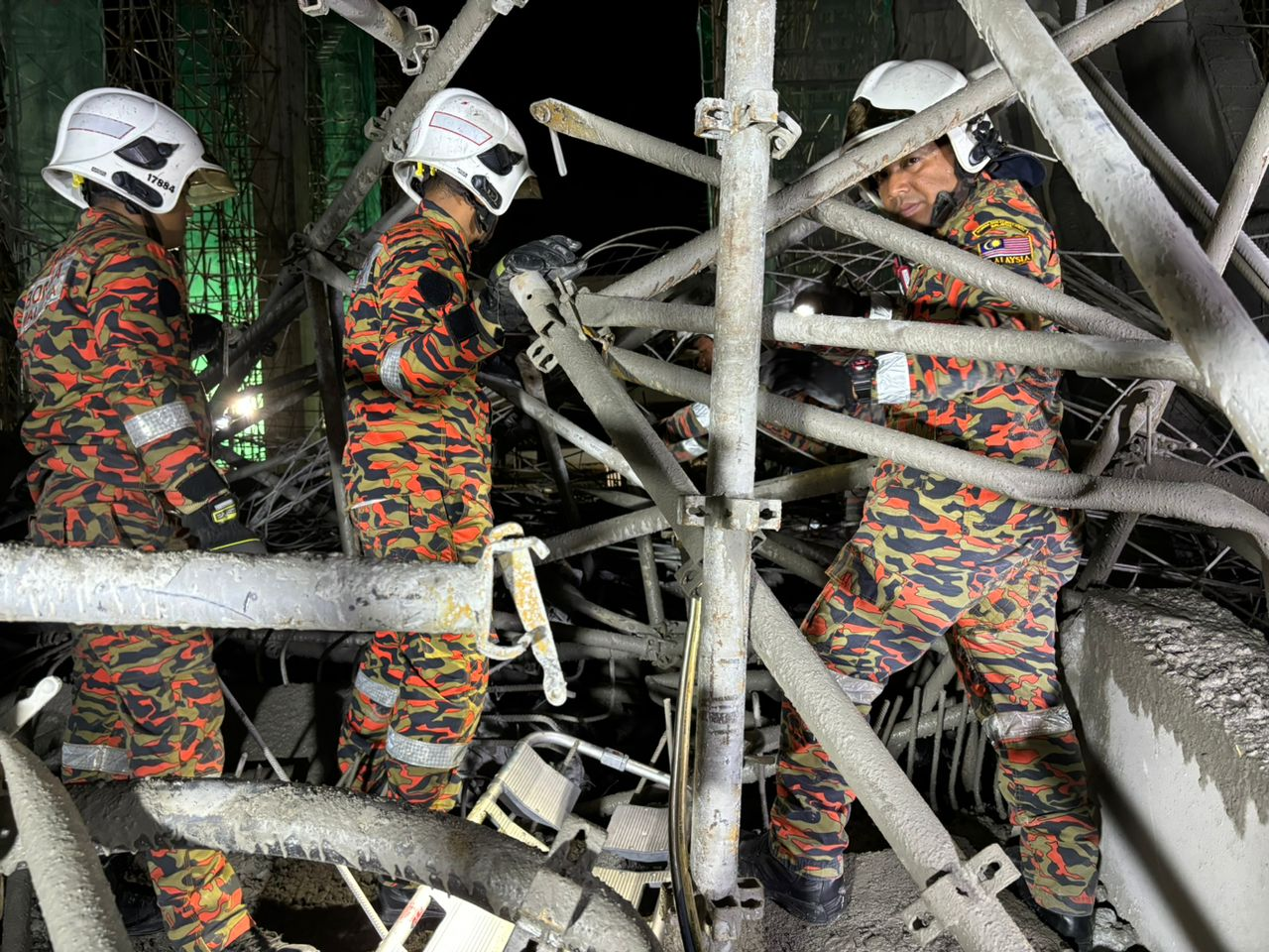 Firefighters looking for victims after building collapses in penang
