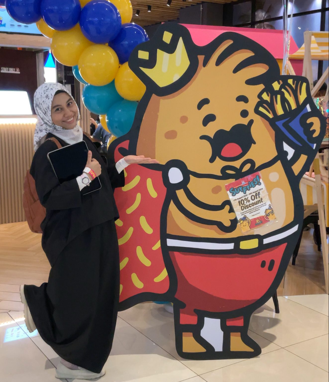 Eqa with her artwork in a mall
