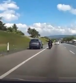 Proton x70 driver uses emergency lane & gets called out by motorcyclist - literally