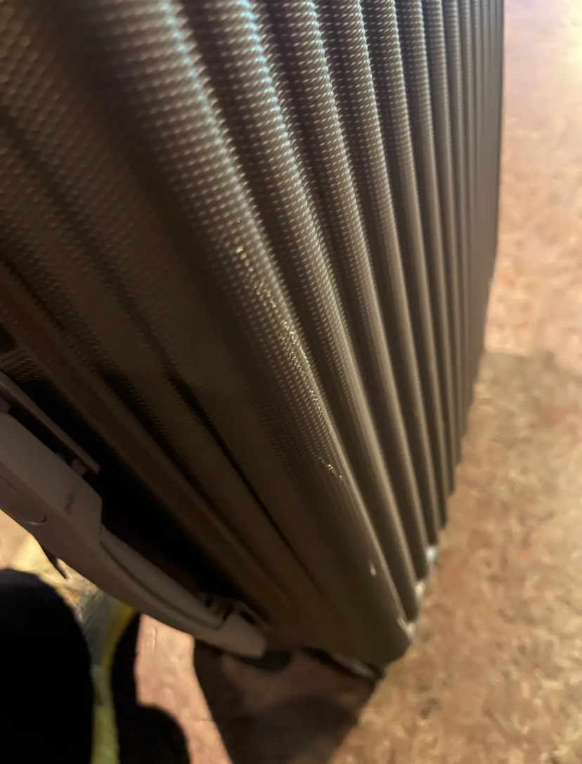 Scratches on black luggage