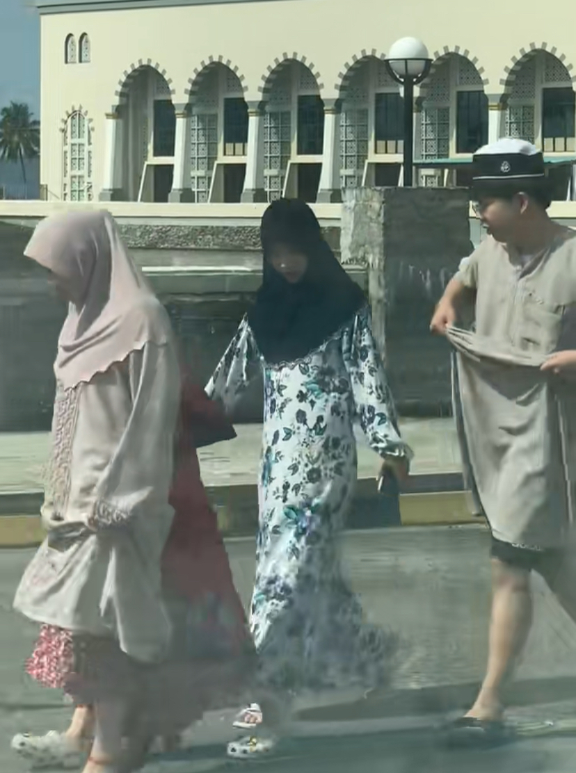 Tourist in hijab and 'jubah' coming back from visiting masjid at sabah