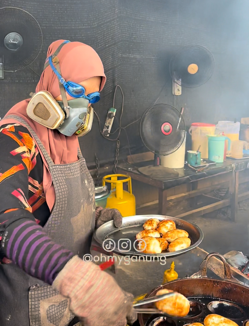 Elderly women in terengganu baking kuih with googles