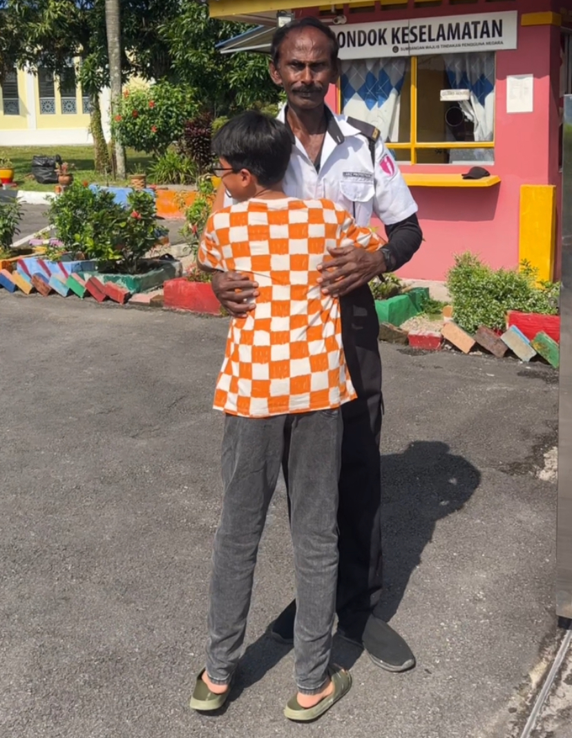 M'sian boy's heartwarming handshake and hug for school security guard wins hearts | weirdkaya