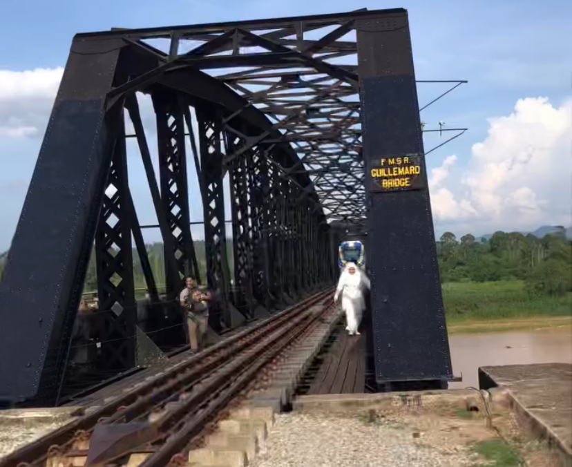 M'sian couple blocks ktm train's path during photoshoot at guillemard bridge in kelantan