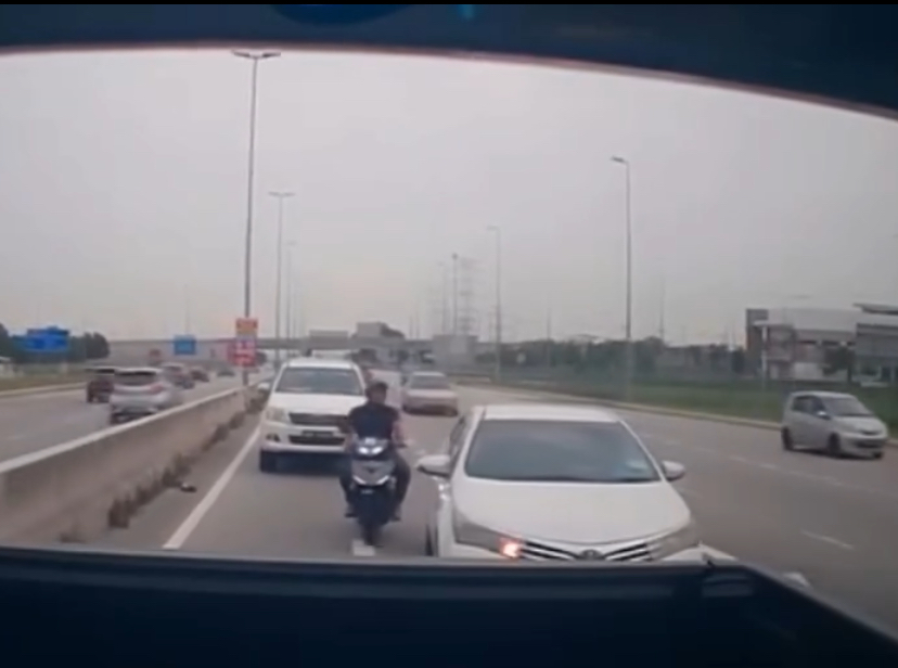 Motorcyclist kicked toyota and fell down