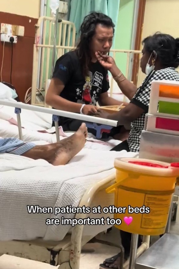 Indian aunty feeding malay man in a hospital