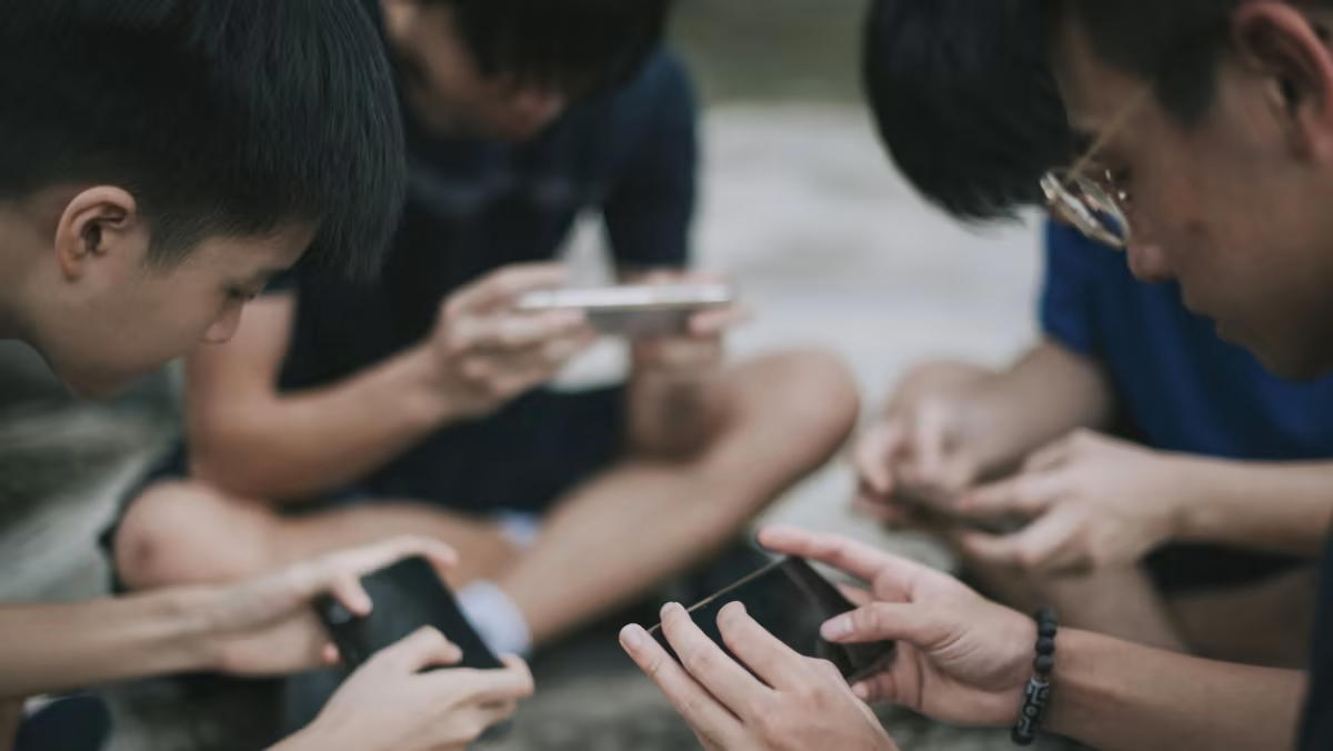 Asian youths using smartphones.