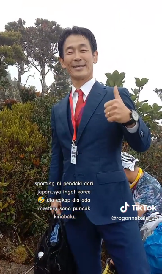 Japanese man climbs mt kinabalu in a suit to attend 'business meeting'