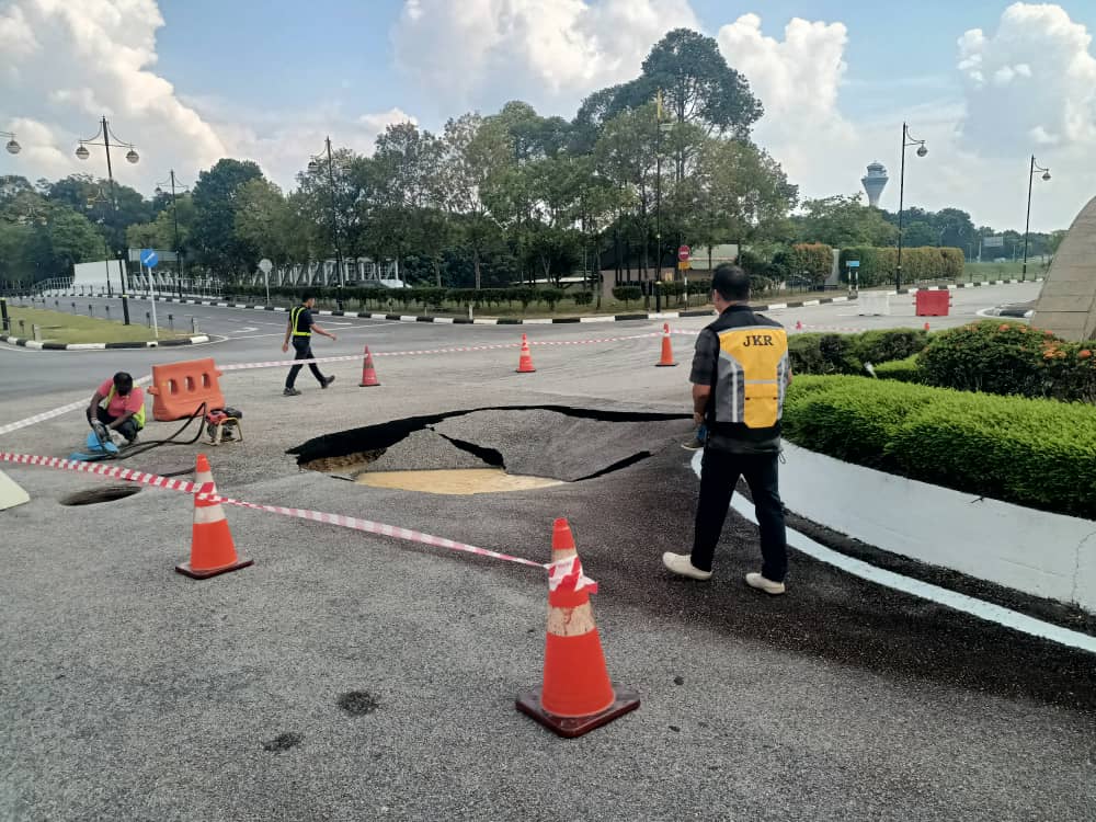 Jkr officers surveying sinkhole at klia's bunga raya complex