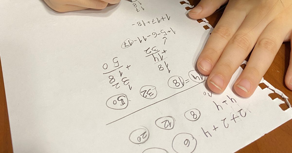 kid is doing her math homework