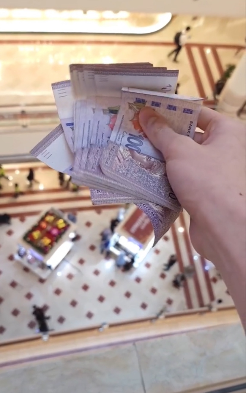 M'sian tiktoker tosses rm100 notes in klcc but netizens aren't sure what to make of it