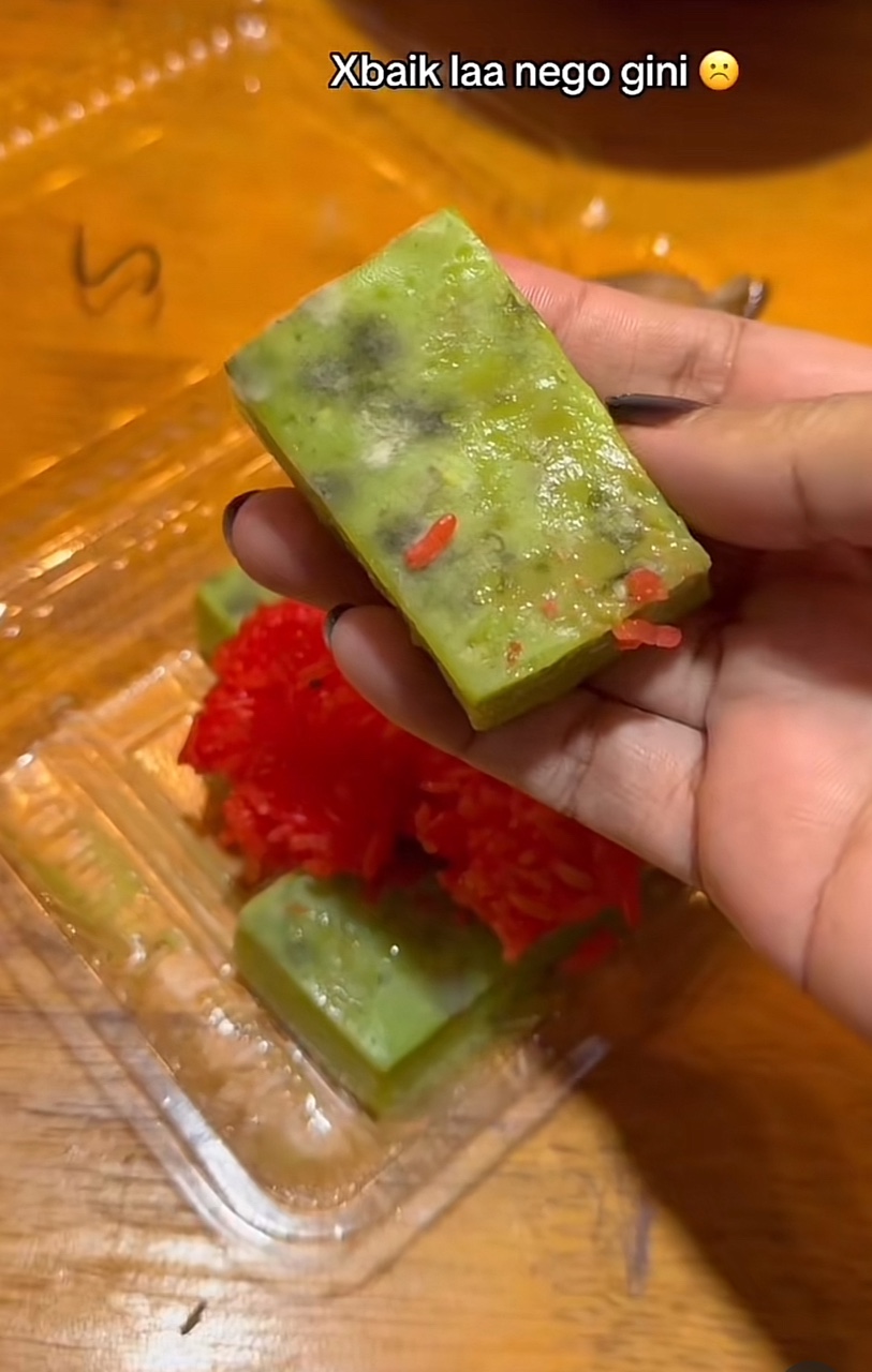 Woman showing kuih filled with mold and fungus on it