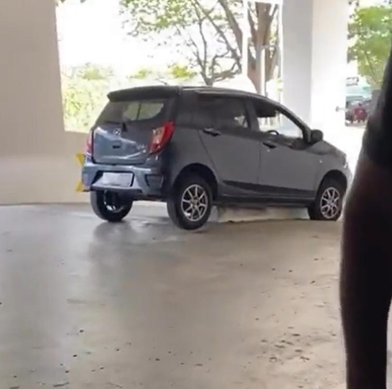 M'sian teen drives perodua axia onto divider while leaving carpark, says she didn't notice it at all | weirdkaya