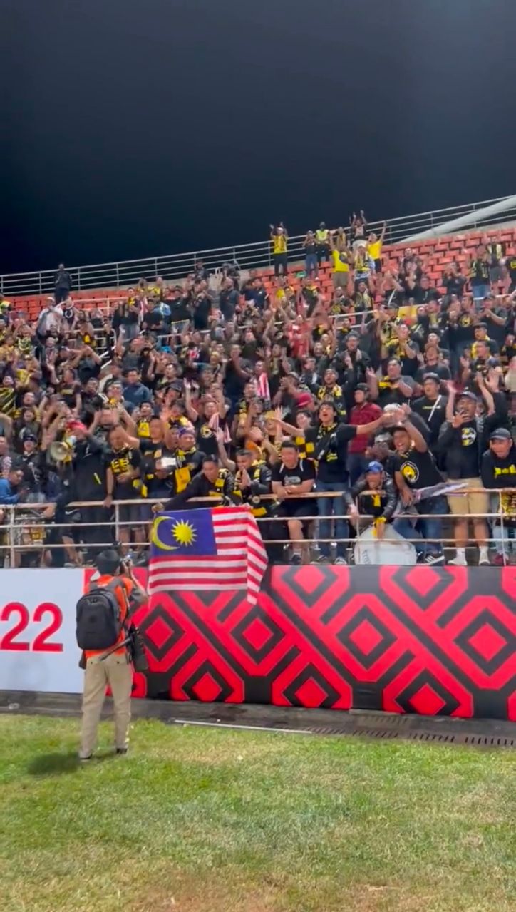 Malaysian football fans cheer for thailand