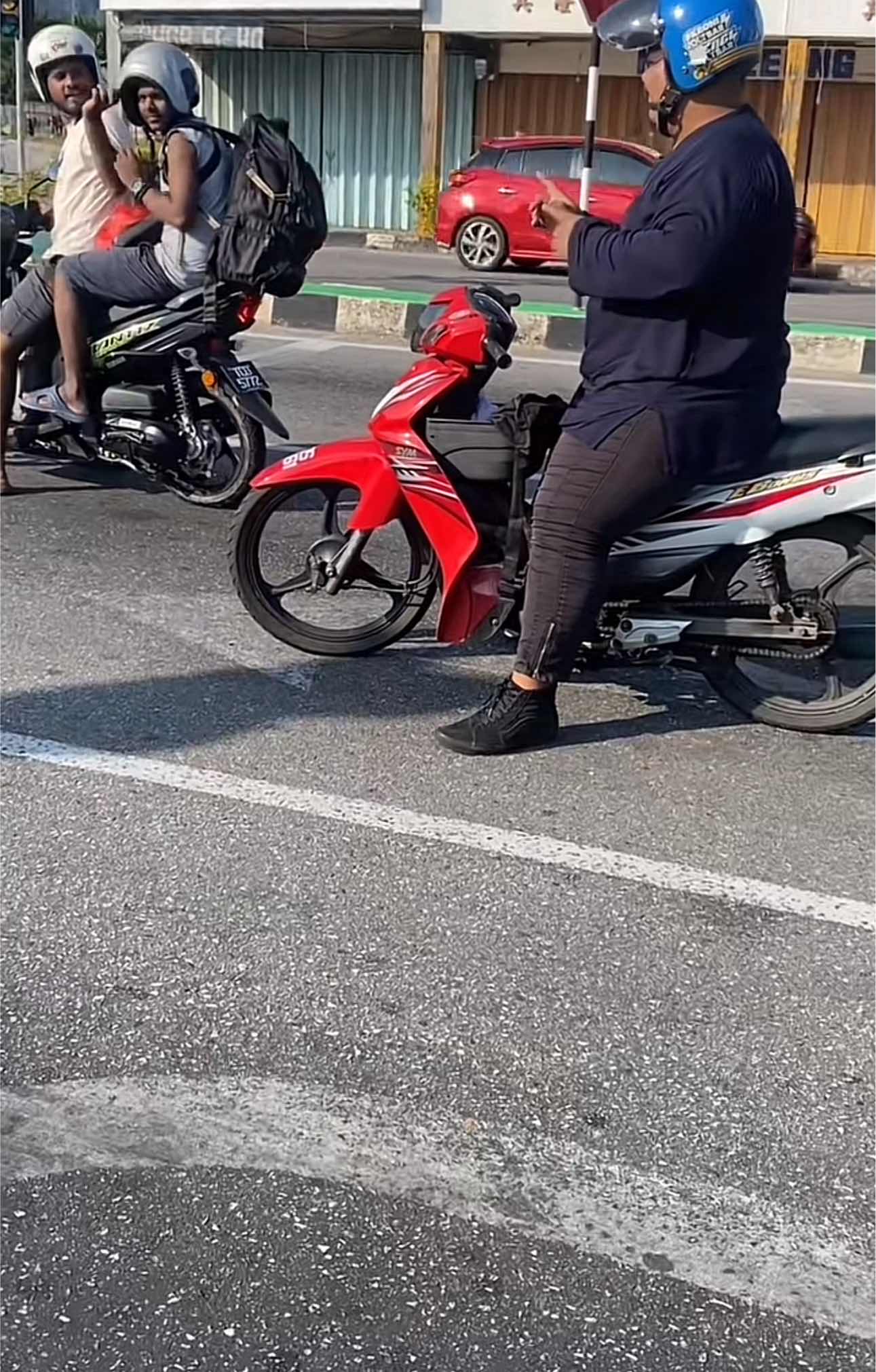Man waiting for traffic light on his motor