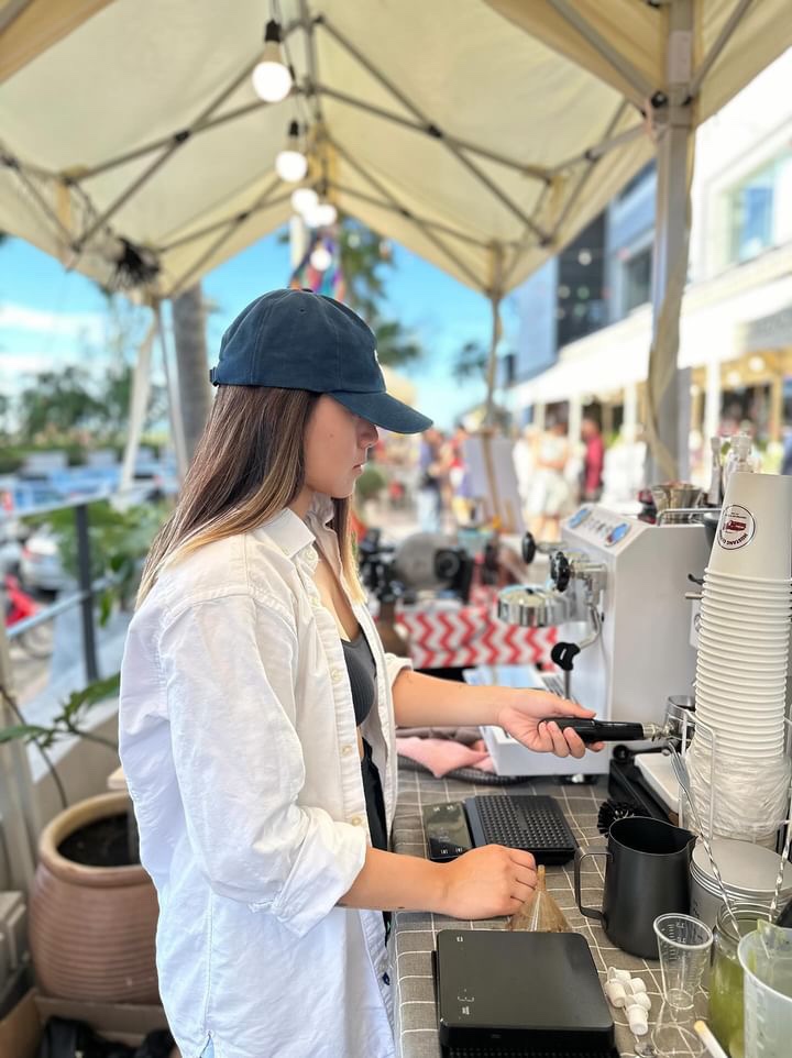 Rochelle making coffee at the shop