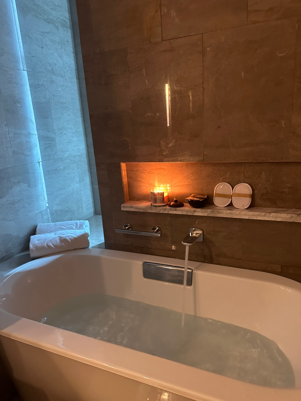 Bathtub in sofitel kuala lumpur with free towels and candles