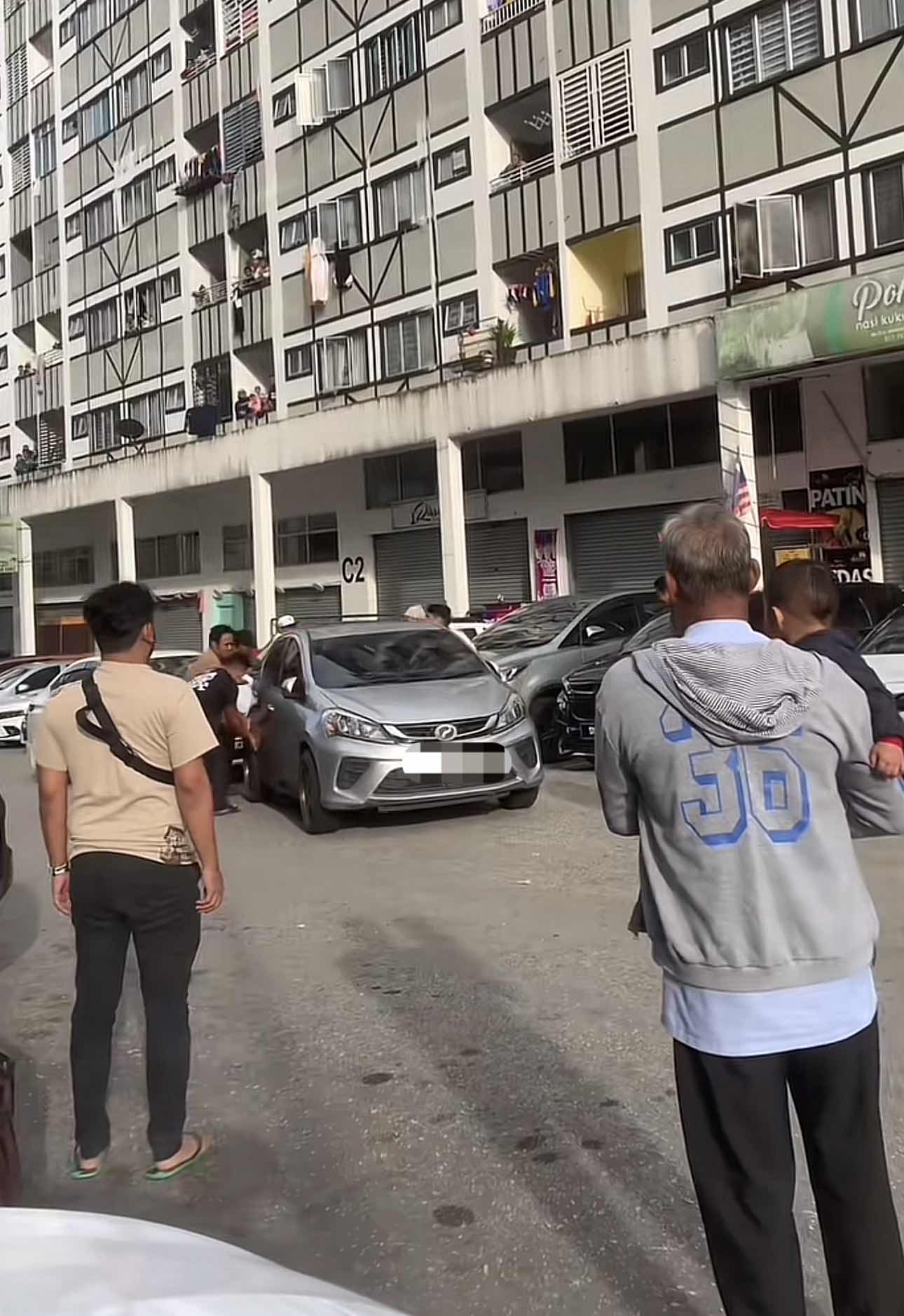 People helping the affected driver to push the car