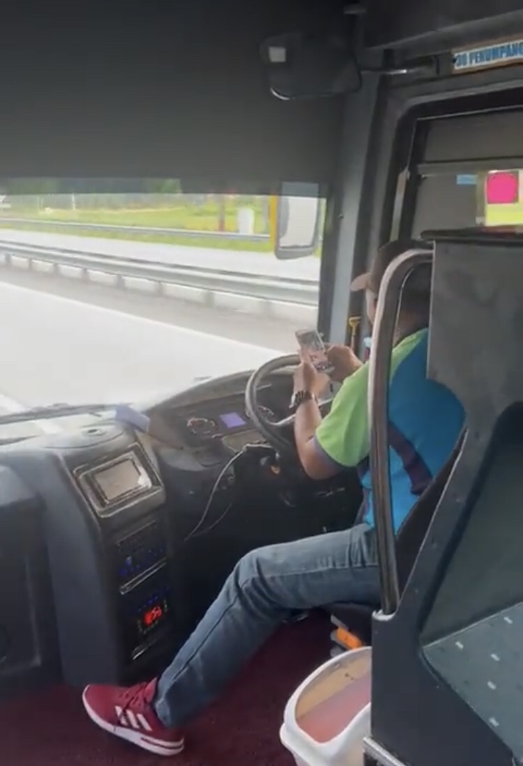 Bus driver uses phone while driving from penang to ipoh