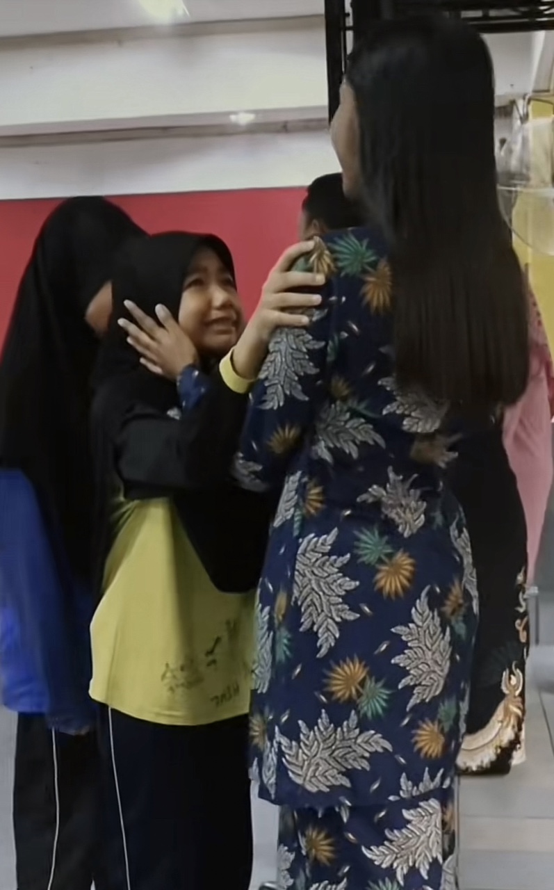 Teacher wiping tears off from her student's eyes