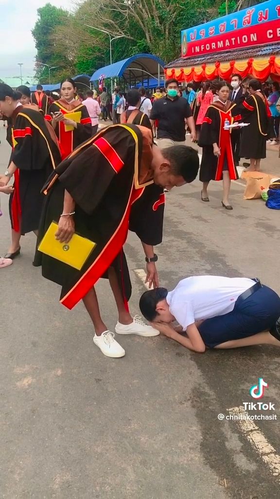 Thai woman bows before her brother's feet to thank him for giving up his education for hers