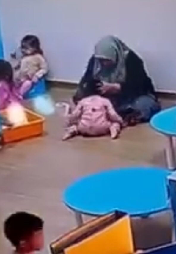 Woman slams the kid's head towards the floor with aggression