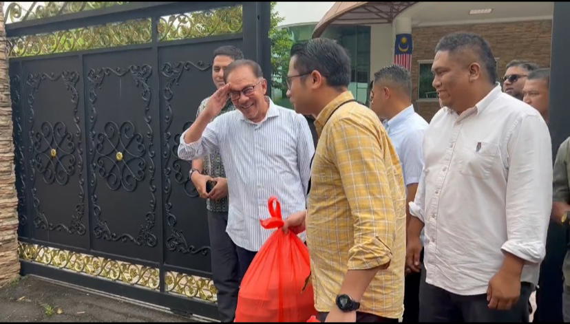 Anwar walks outside his office with 