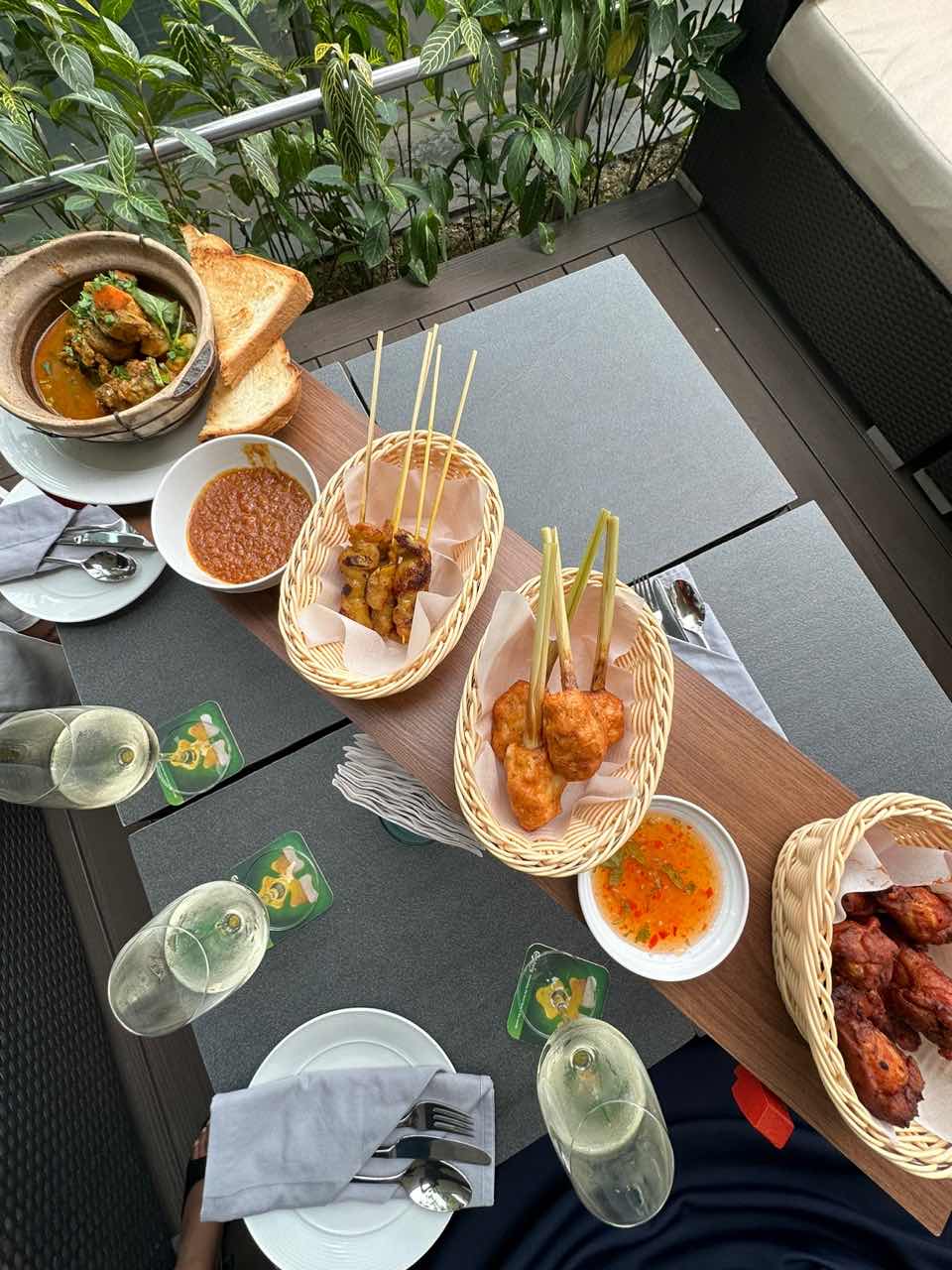 A platter filled with malaysian cuisine and satay